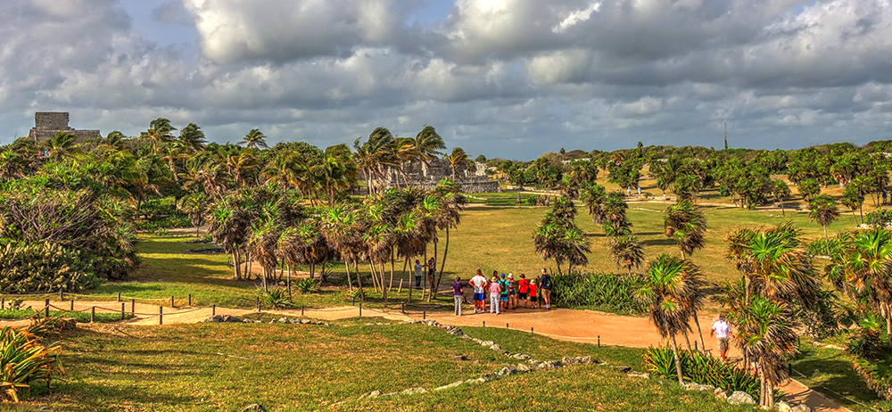Landscape image of the Horse Club with guests admiring the property