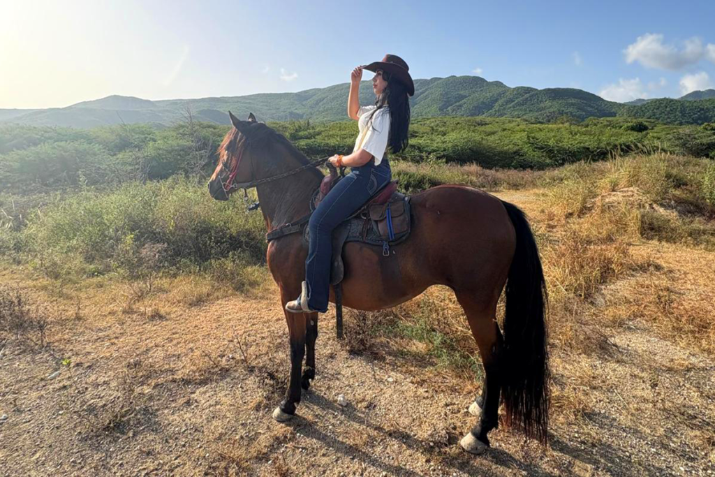 Woman taking in the outdoors while on horseback ride at Rancho DM Horse Club