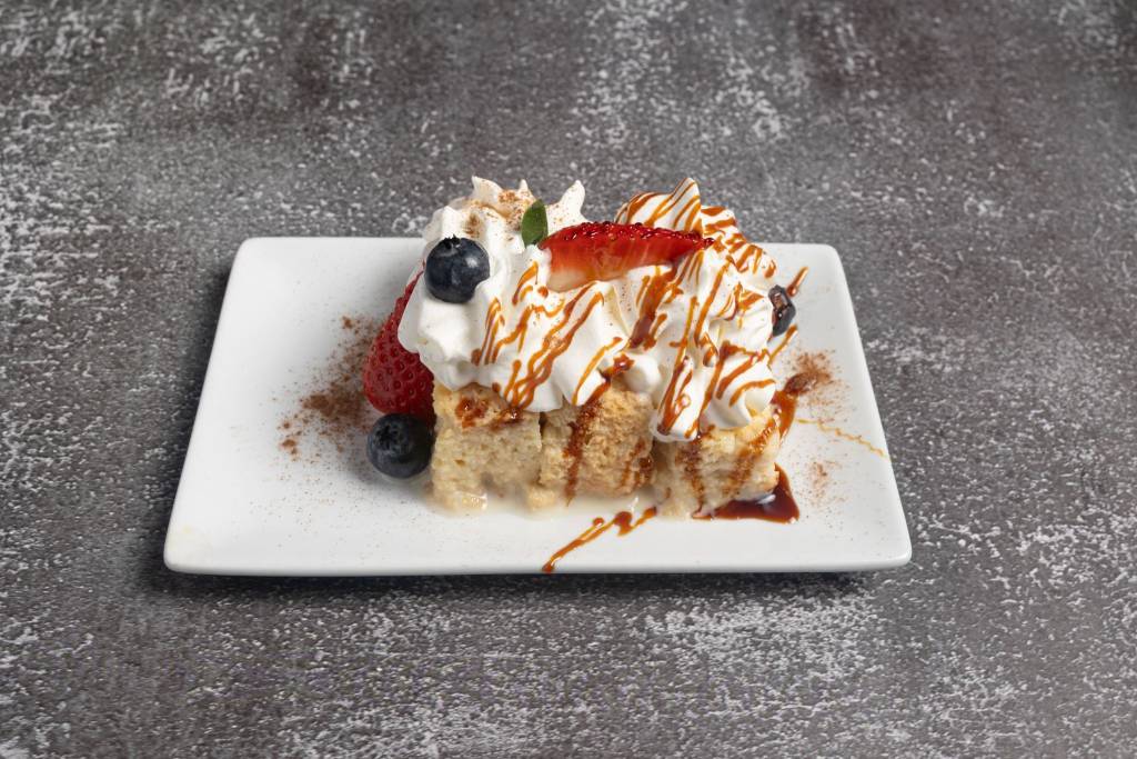 Moist Dominican tres leches cake with berries and cream