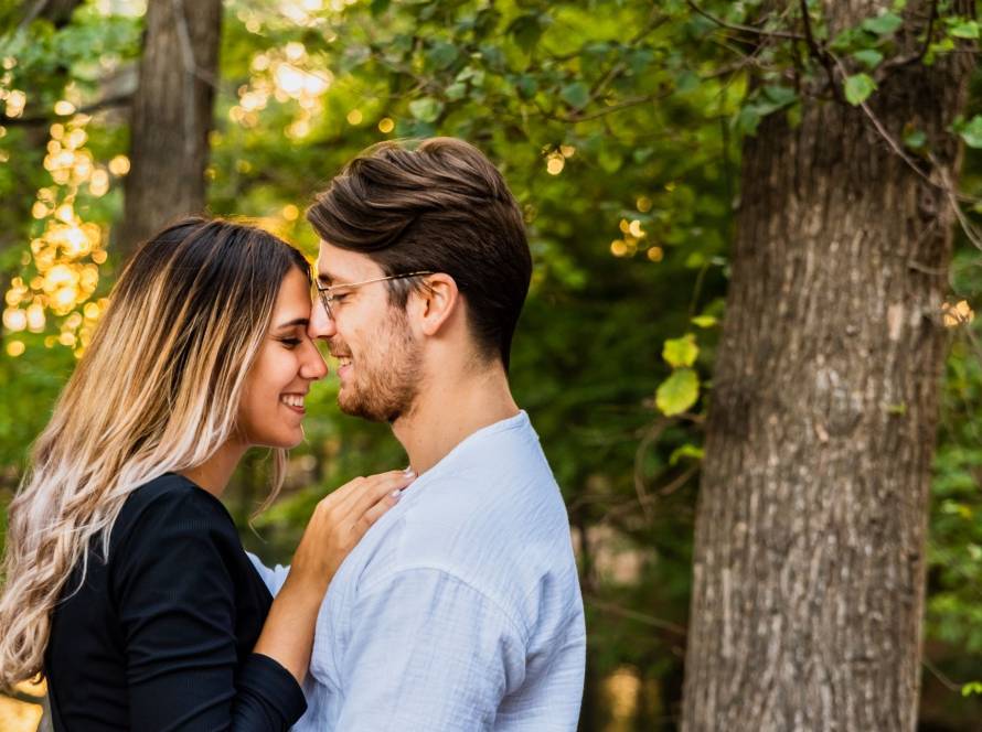 Engagement photo of a couple sharing an intimate moment in a lush garden setting