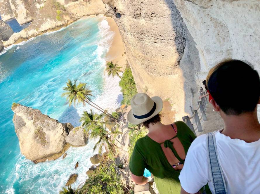 Rear view of visitors walking down to a tropical beach in the Dominican Republic